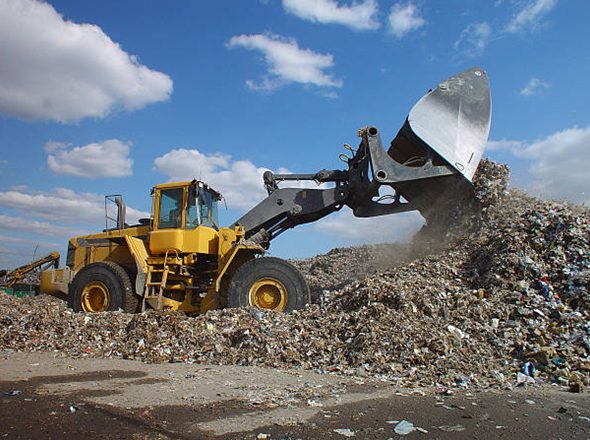 Loader moving waste at a landfill site